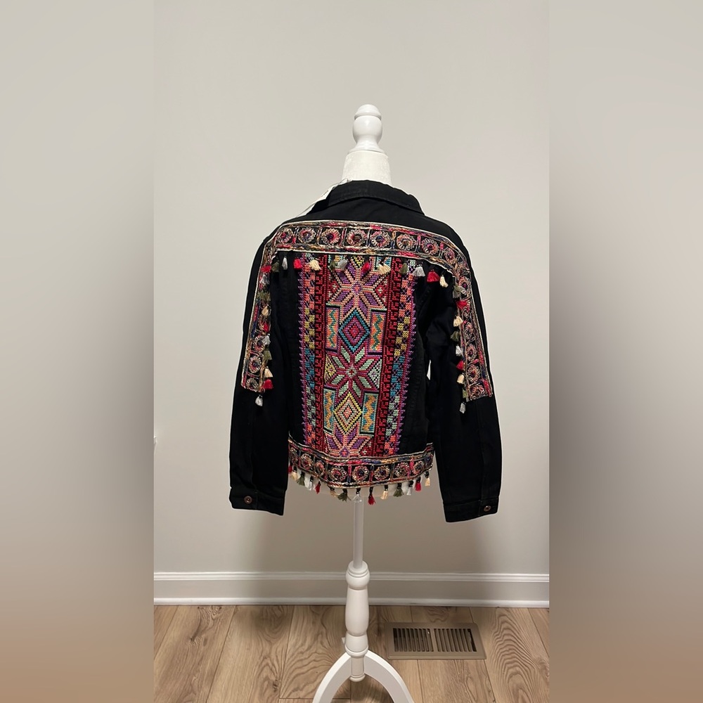 Black denim jacket with colorful embroidery and tassels